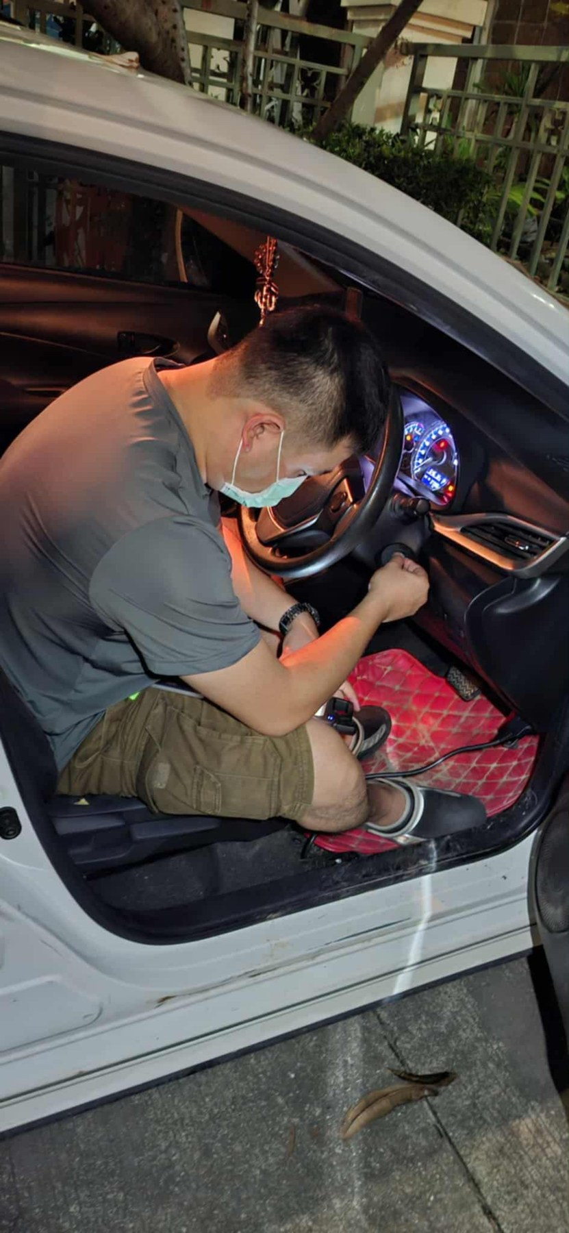 Technician working inside a vehicle during a car key programming job